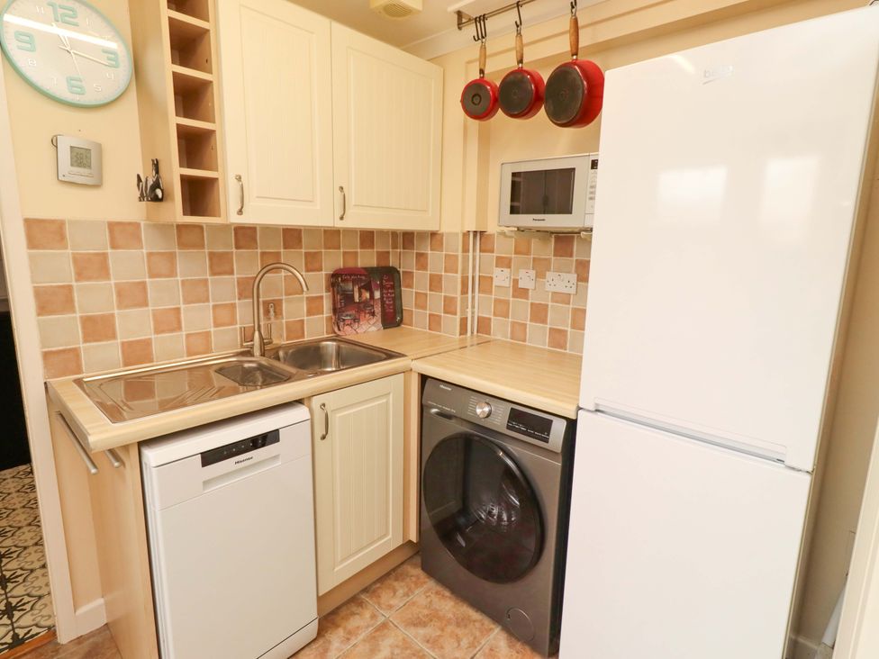 A kitchen with appliances and cabinets at Rose Briar Cottage in Morpeth
