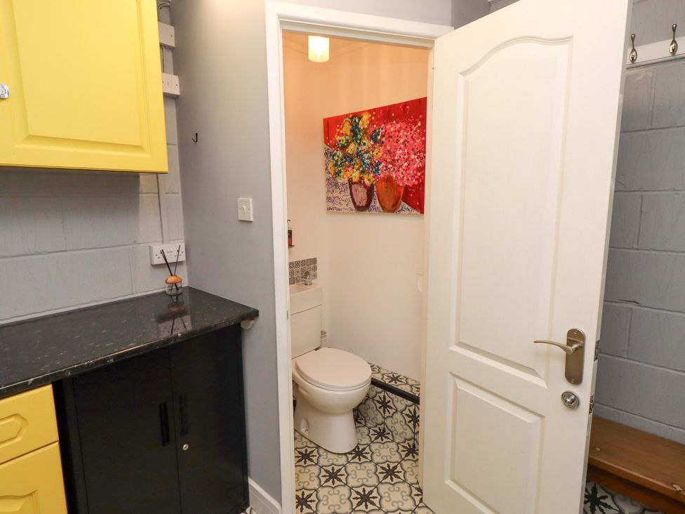 A bathroom with a toilet and sink at Rose Briar Cottage in Morpeth