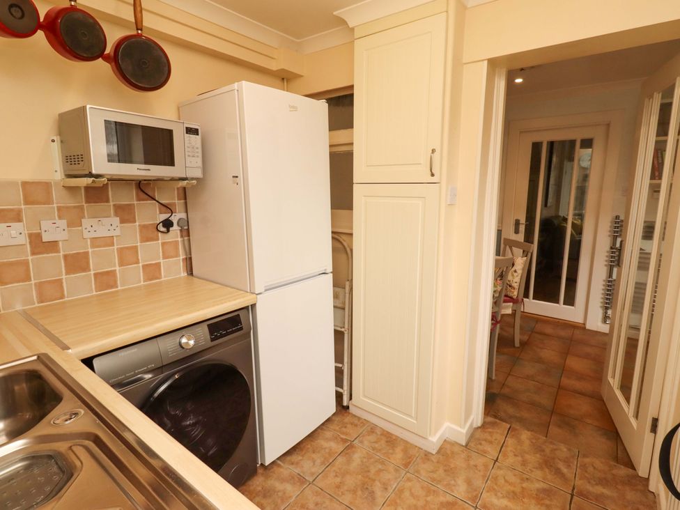 A kitchen with appliances and cabinets at Rose Briar Cottage in Morpeth
