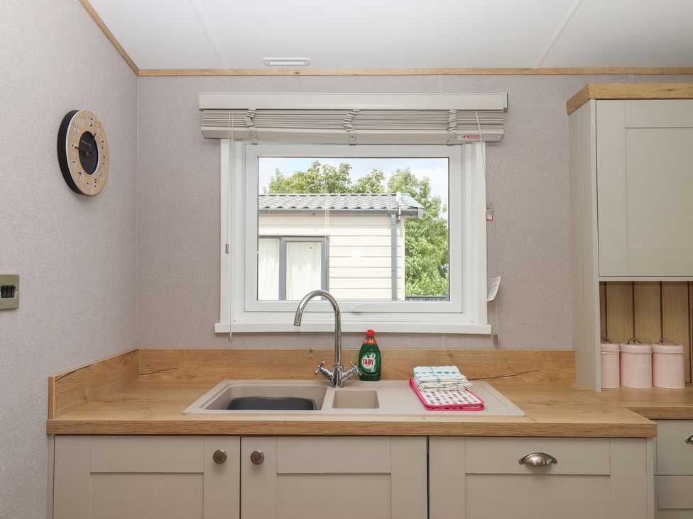 A kitchen with a sink and tap at Maple Lodge Teigngrace near Kingsteignton