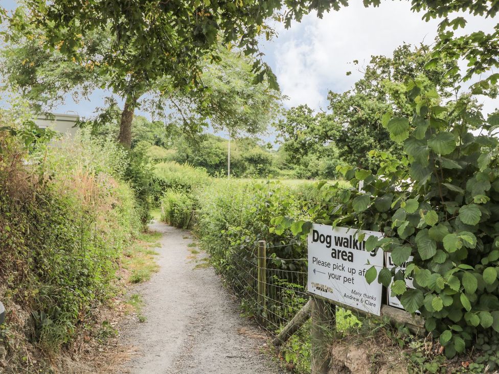A path with a dog walking area sign at Maple Lodge Teigngrace near Kingsteignton
