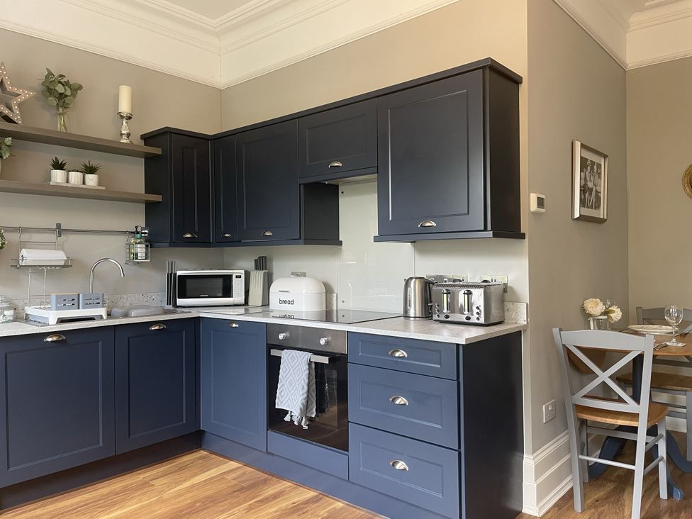 A kitchen with cabinets and appliances at DeCressy Apartment in Par