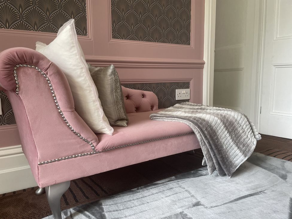 A sofa with cushions and a blanket in DeCressy Apartment in Par