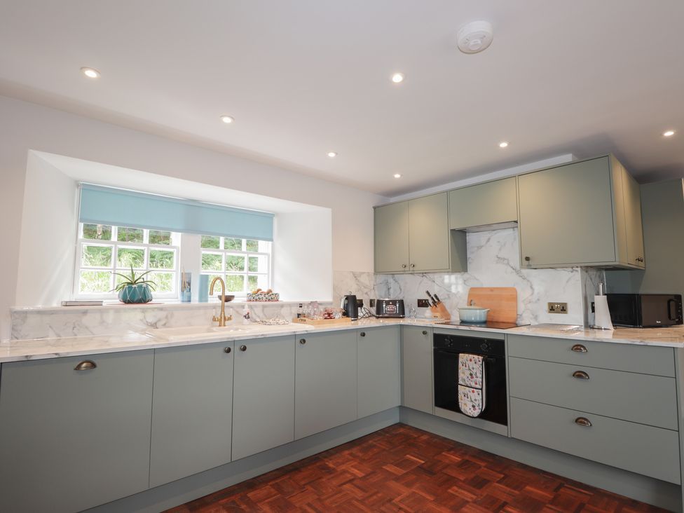 A kitchen with cabinets and a sink at Sron Dubh in Achnasheen