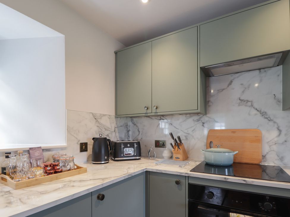 A kitchen with cabinets and appliances at Sron Dubh Achnasheen