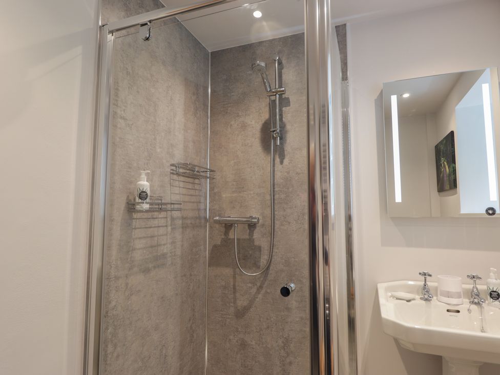 A shower with a sink and mirror in Sron Dubh Achnasheen