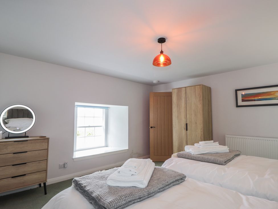 A bedroom with two beds and a dresser at Sron Dubh in Achnasheen