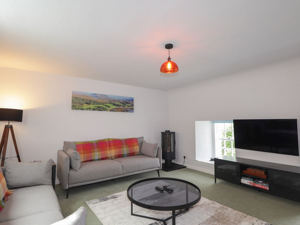 A living room with a sofa and television at Sron Dubh Achnasheen