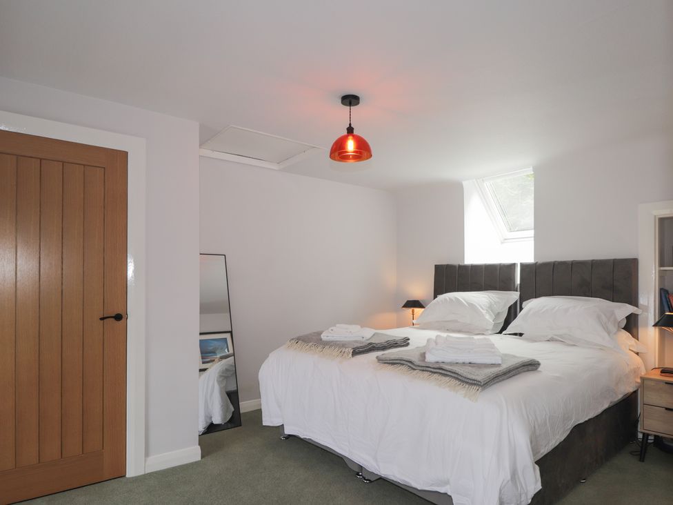 A bedroom with two beds and a mirror at Sron Dubh Achnasheen