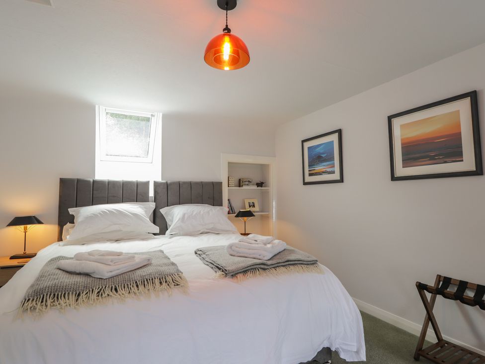 A bedroom with a bed and a lamp at Sron Dubh in Achnasheen