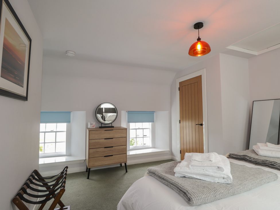 A bedroom with a bed and dresser at Sron Dubh in Achnasheen