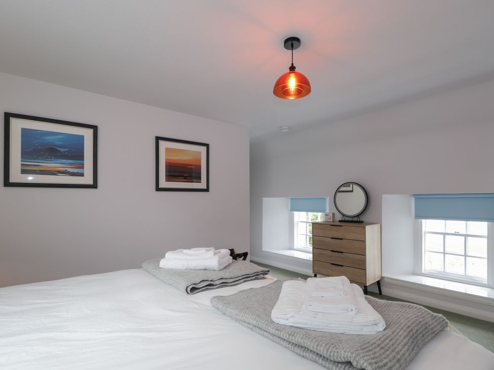 A bedroom with a bed and dresser at Sron Dubh Achnasheen
