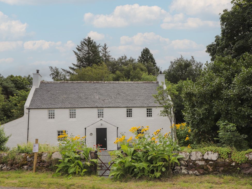 A house with a gate and flowers in the garden at Sron Dubh Achnasheen