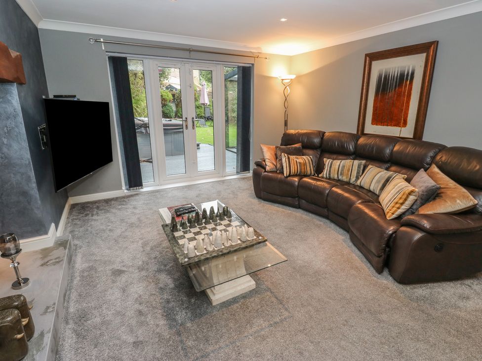 A living room with a sofa and coffee table at 20 Overland Crescent in Apperley Bridge
