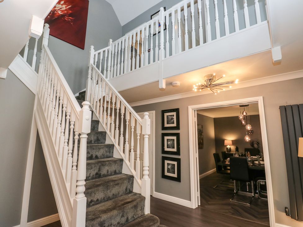 A hallway with stairs and a doorway at 20 Overland Crescent Apperley Bridge