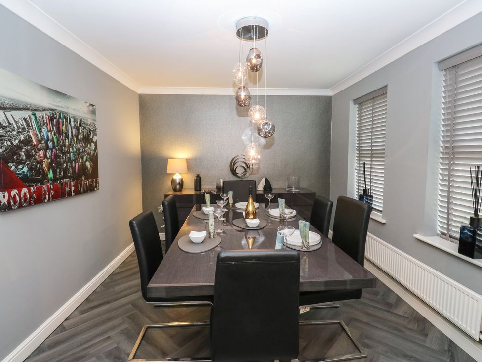 A dining room with a table and chairs at 20 Overland Crescent in Apperley Bridge