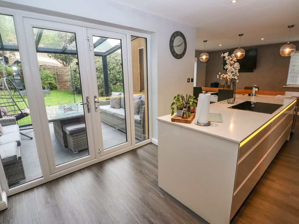 A kitchen with a dining table and sofa visible at 20 Overland Crescent in Apperley Bridge