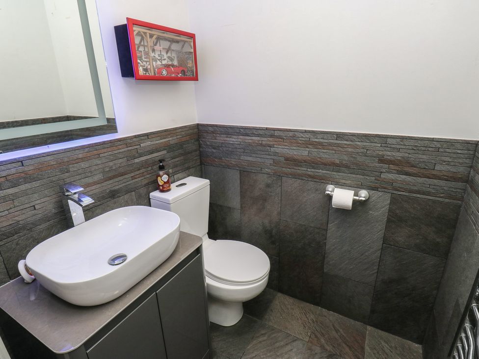 A bathroom with a sink and toilet at 20 Overland Crescent in Apperley Bridge