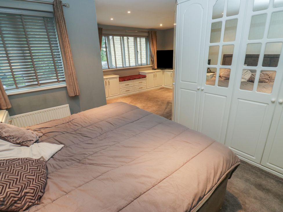 A bedroom with a bed and wardrobe at 20 Overland Crescent in Apperley Bridge
