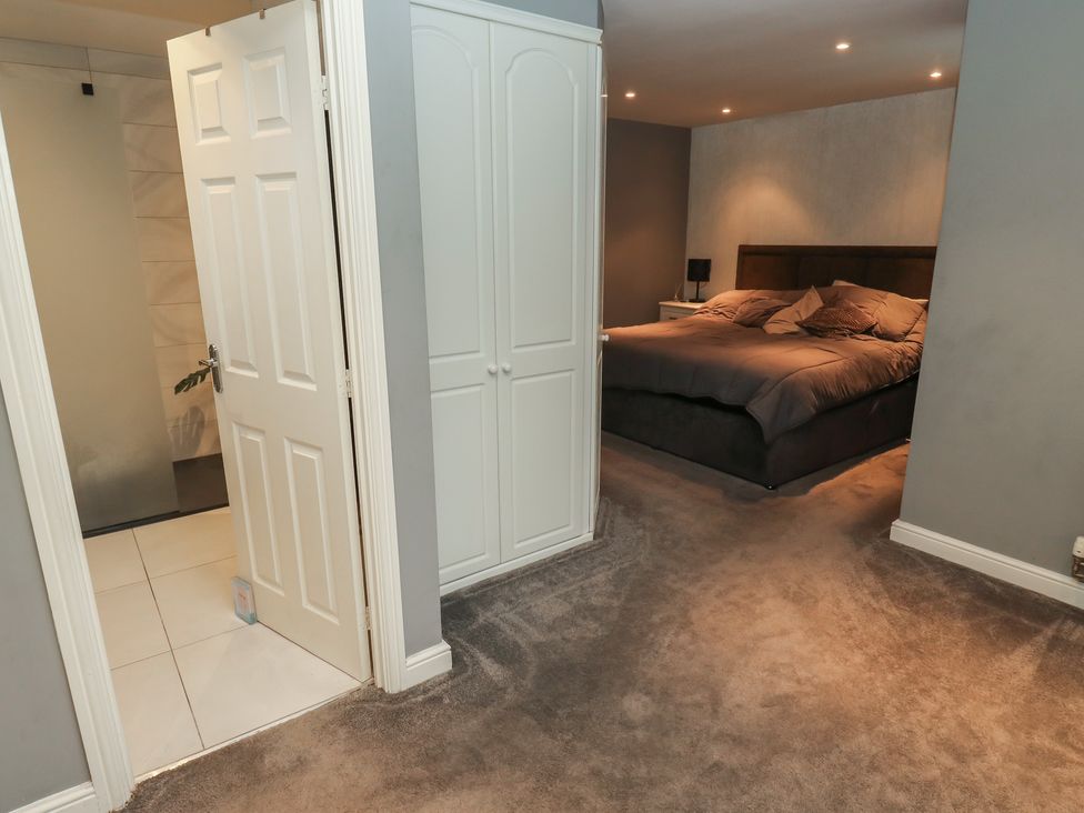 A bedroom with a bed and wardrobe at 20 Overland Crescent in Apperley Bridge