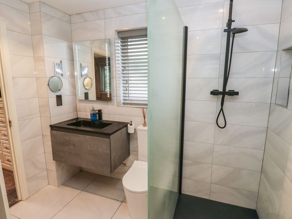 A bathroom with a sink toilet and shower at 20 Overland Crescent in Apperley Bridge