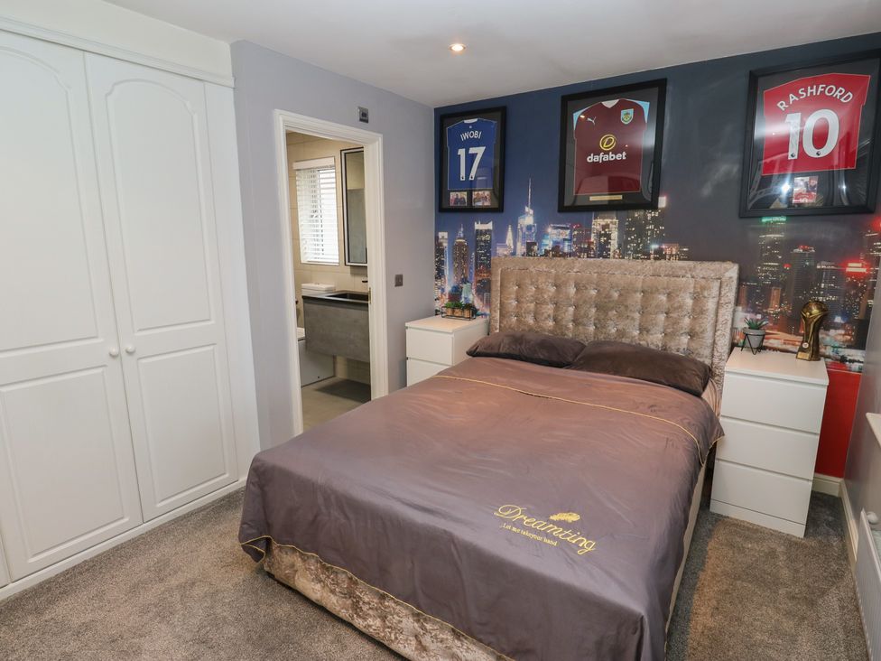 A bedroom with a bed and wardrobe at 20 Overland Crescent in Apperley Bridge