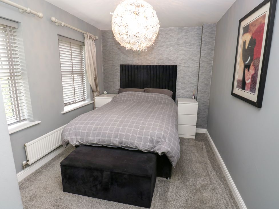 A bedroom with a bed and bedside table at 20 Overland Crescent Apperley Bridge