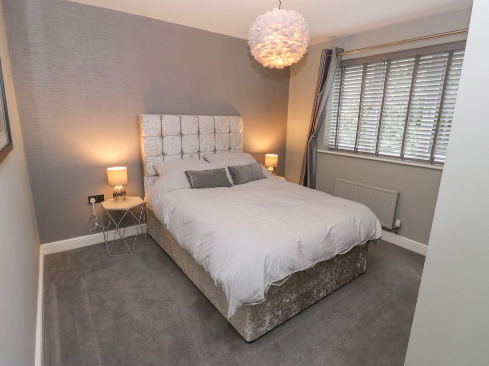 A bedroom with a bed and window at 20 Overland Crescent in Apperley Bridge