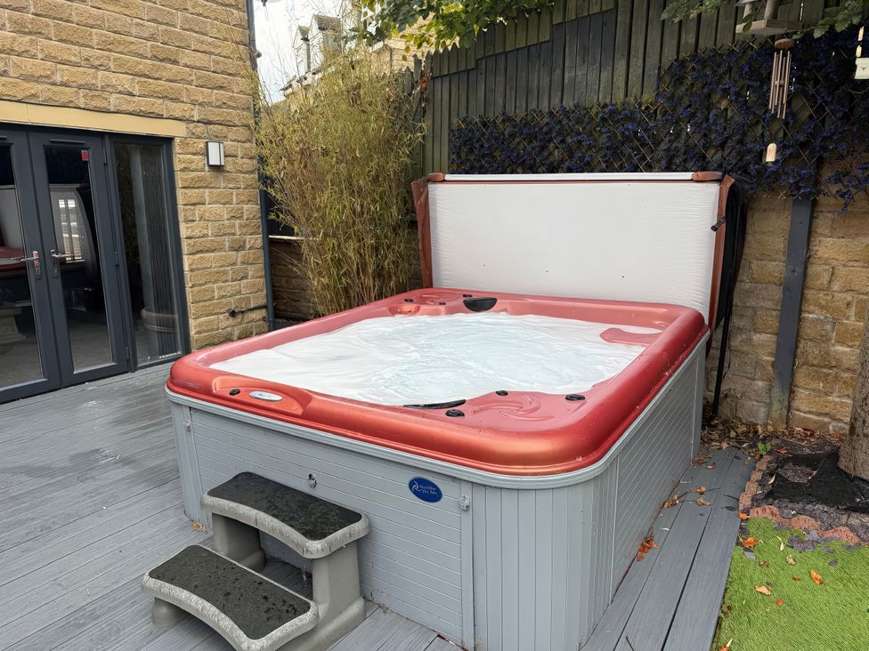 A hot tub with steps beside it in an outdoor area at Corriegale in Apperley Bridge