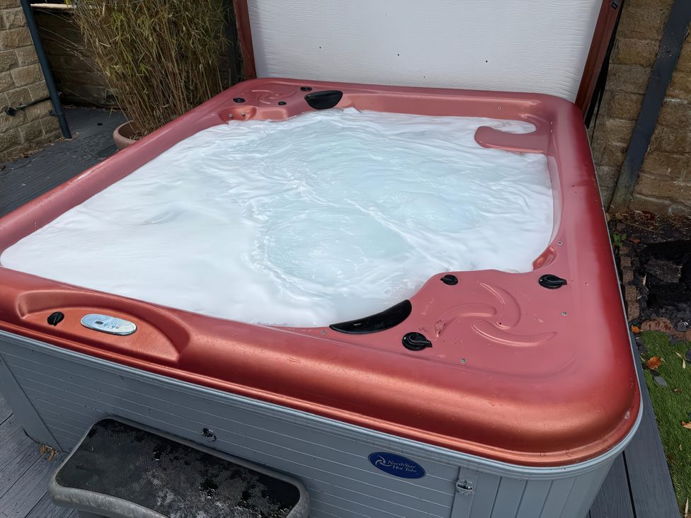 A hot tub with bubbling water in an outdoor area at Corriegale in Apperley Bridge