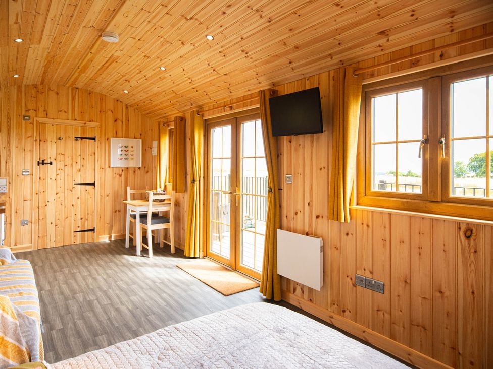 A glamping hut interior with wooden features at Head For the Hills Glamping - Skylark Shepherd's Hut