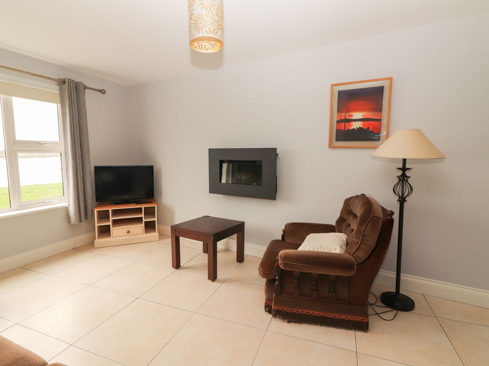 A living room with a television and a sofa at 1 Windermere in Kinvarra