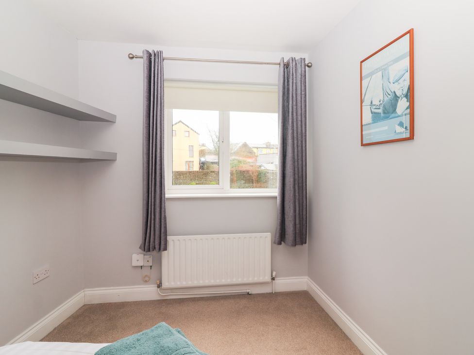 A bedroom with a window and shelves at 1 Windermere in Kinvarra