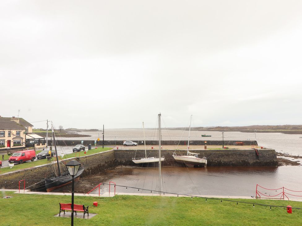 A waterfront view with sailboats and cars at 1 Windermere in Kinvarra