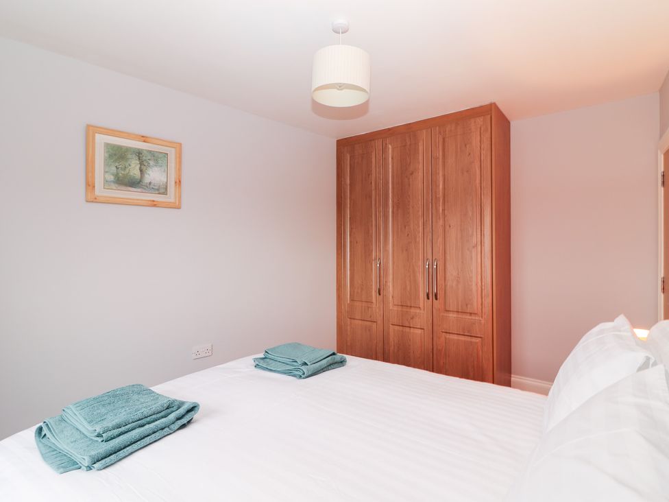 A bedroom with towels on the bed at 1 Windermere in Kinvarra