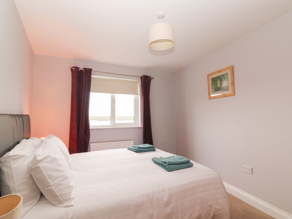 A bedroom with a bed and window at 1 Windermere in Kinvarra