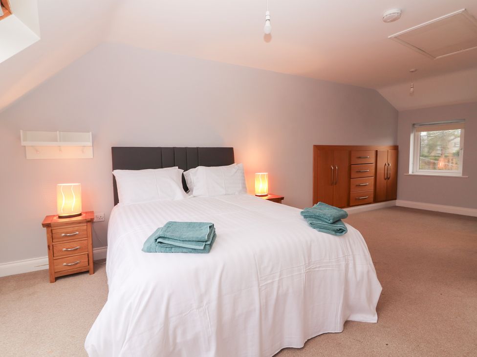 A bedroom with a double bed and a dresser at 1 Windermere in Kinvarra