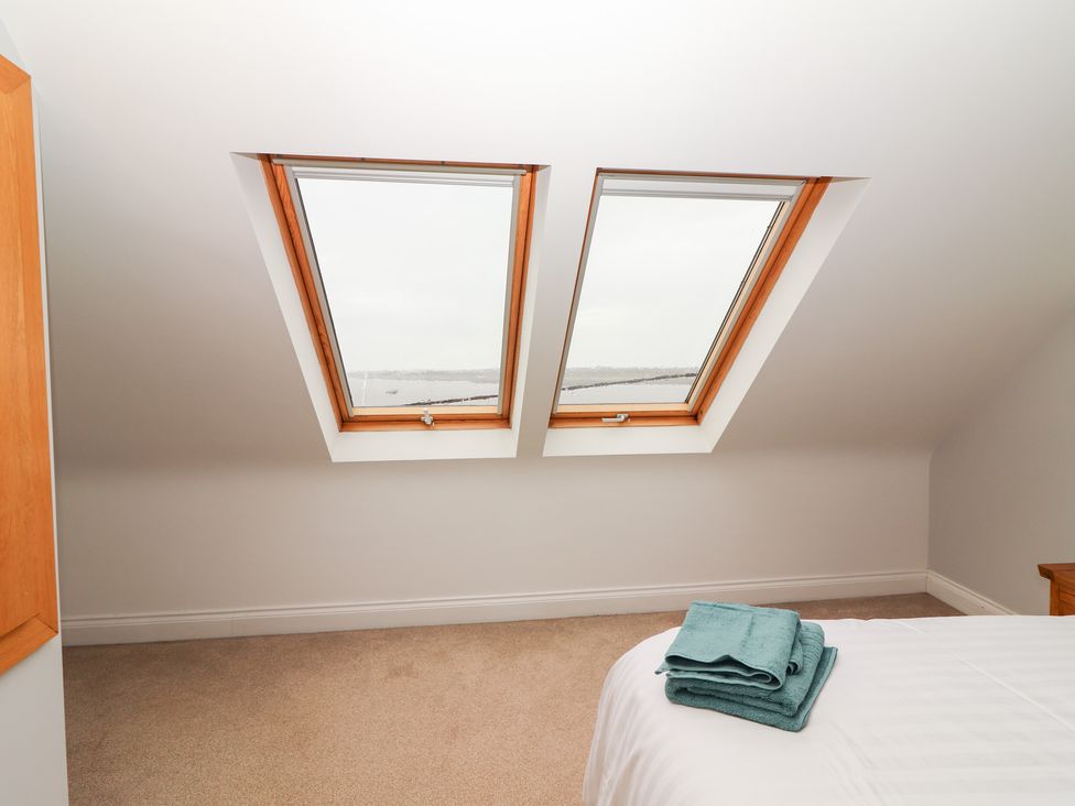 A bedroom with roof windows and towels on the bed at 1 Windermere in Kinvarra
