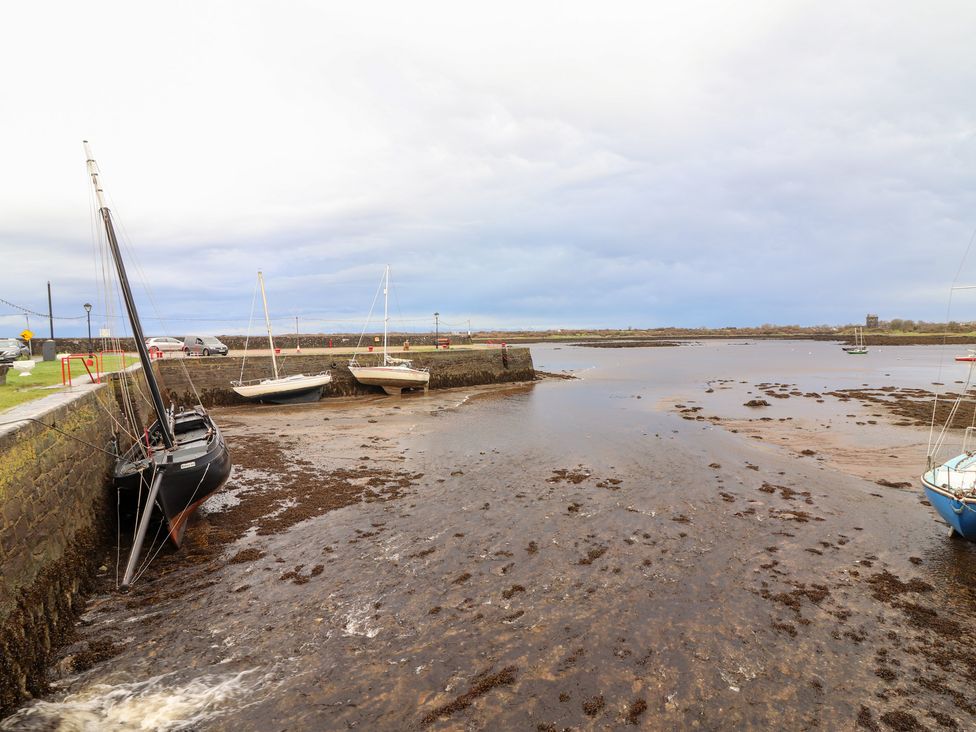 Boats at low tide near a pier at 1 Windermere in Kinvarra