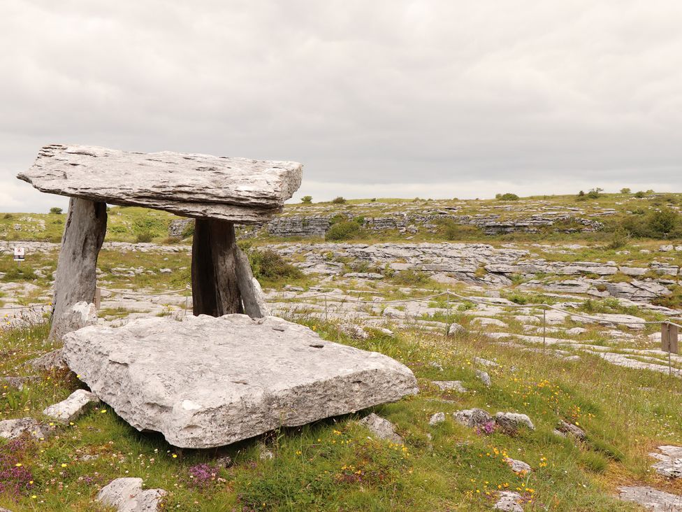 A stone table surrounded by grass and rocks at 1 Windermere in Kinvarra