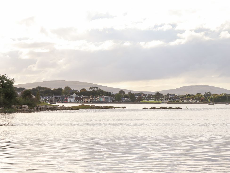 A view of water with buildings and hills in the background at 1 Windermere in Kinvarra