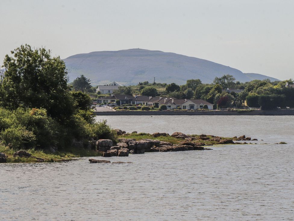 A view of a mountain overlooking water and houses near the shore at 1 Windermere, Kinvara, County Galway