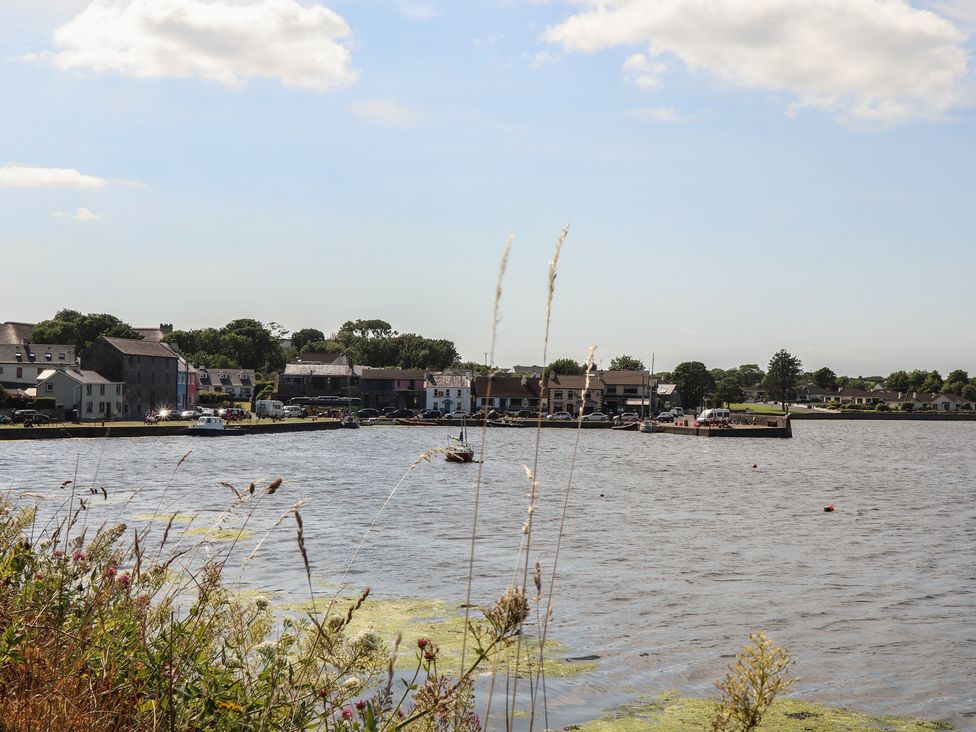 A view of a river with houses and boats at 1 Windermere in Kinvara, County Galway
