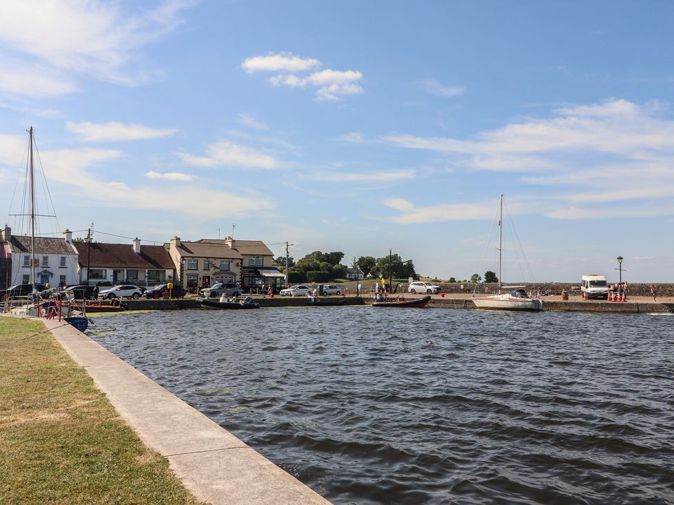 A view of boats near buildings along the water at 1 Windermere in Kinvara, County Galway