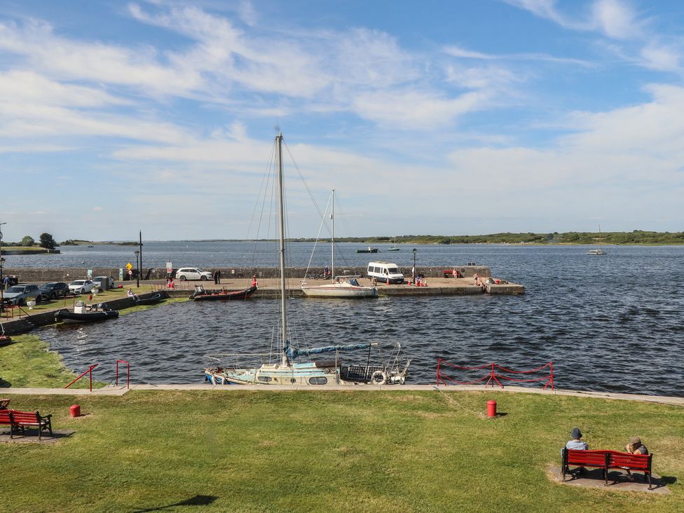 A view of a harbor with boats and people sitting on benches at 1 Windermere in Kinvara, County Galway