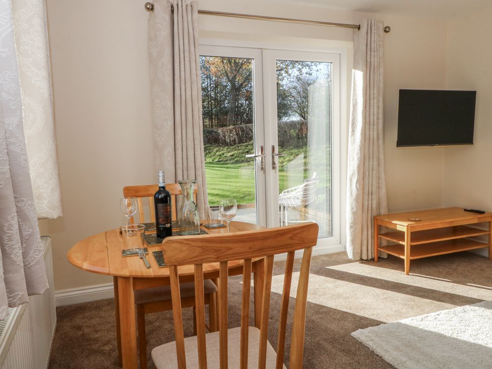 A dining room with a table and chairs at The Annexe in Caverswall