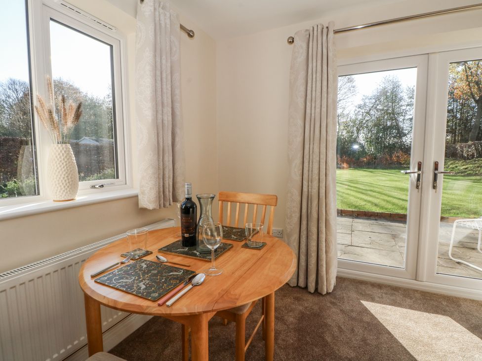 A dining room with a table and chairs at The Annexe in Caverswall