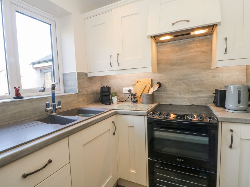 A kitchen with a sink and cooker at The Annexe in Caverswall