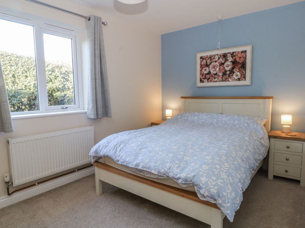 A bedroom with a bed and window at The Annexe in Caverswall