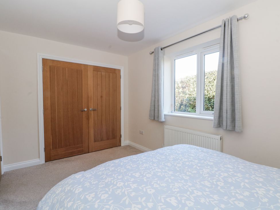 A bedroom with a bed and window at The Annexe in Caverswall
